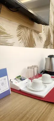 a tray with plates and bowls on a table at Sree Nandhanam apartment's in Guruvāyūr