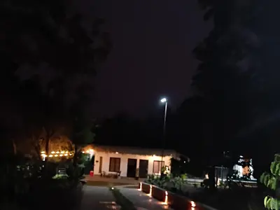 a night view of a building with a street light at Forest Brew Resort Wayanad in Chekadi