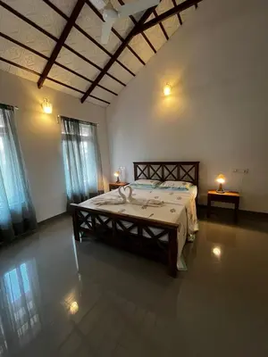 a bedroom with a large bed in a room at Birdsong Coffee Estate Stay in Madikeri