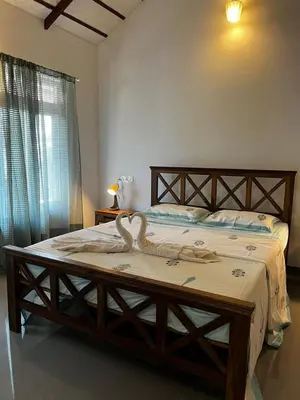 a bedroom with a bed with a snake on it at Birdsong Coffee Estate Stay in Madikeri