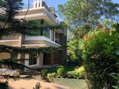 a house with a garden in front of it at Athirapilly Ontherocks in Athirappilly