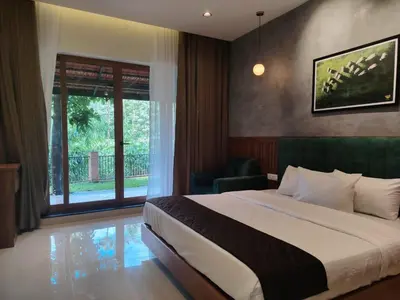 a hotel room with a bed and a window at Athirapilly Ontherocks in Athirappilly