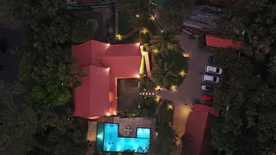 an overhead view of a house with a swimming pool at night at Athirapilly Ontherocks in Athirappilly