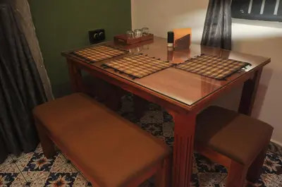 a wooden desk with a keyboard and a chair at WellGrown- The Farmhouse at Kombai - Pallangi, Kodaikanal in Kodaikānāl