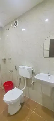 a bathroom with a toilet and a sink at VKJ Lodge in Alwaye