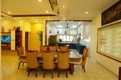 a dining room with a table and chairs at Welcome to SP Luxury Bed Villa in Kāladi