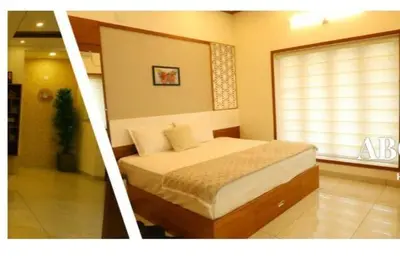 a bedroom with a large bed with a window at Welcome to SP Luxury Bed Villa in Kāladi