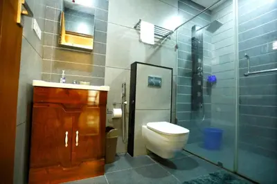 a bathroom with a toilet and a sink and a shower at Welcome to SP Luxury Bed Villa in Kāladi