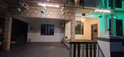 a hallway of a house at night with lights at Airport villa in Chewarra