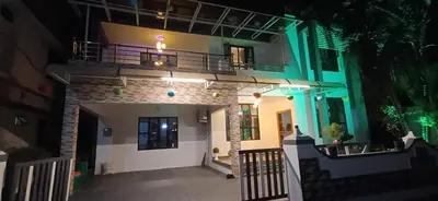 a view of a building at night at Airport villa in Chewarra