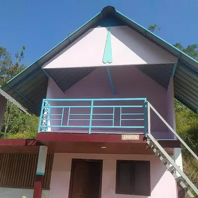 a house with a balcony on the top of it at haven bridge Homestay in Meenangadi