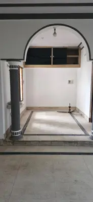 an empty room with a bed in a building at Shariff Villa in Mysore