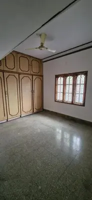 an empty room with two windows and a ceiling at Shariff Villa in Mysore