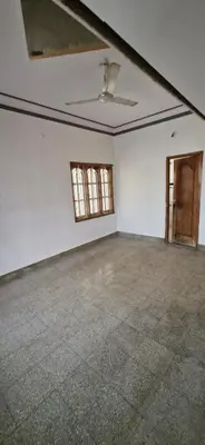 an empty room with white walls and a ceiling at Shariff Villa in Mysore