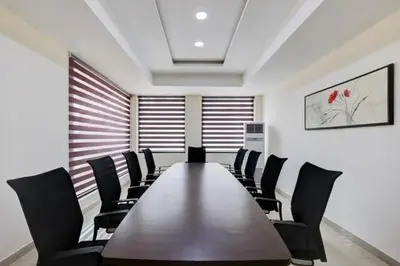 a conference room with a wooden table and chairs at Hotel Grand Regency, Angamaly in Angamali