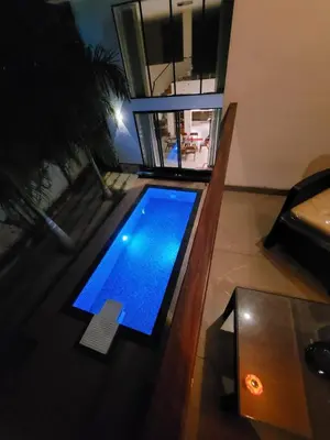 an overhead view of a swimming pool in a living room at Aurora The Pool Villa ll in Kozhikode