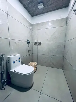 a bathroom with a toilet in a room at Elegant Mountain Resort in Kalpetta