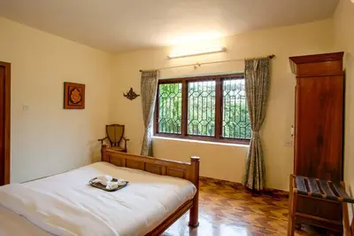 a bedroom with a bed and a window at Away From Home - 2 - Home Stay Ooty, Entire 4BHK Villa in Ooty