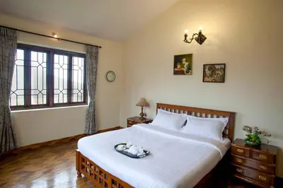 a bedroom with a large bed and a window at Away From Home - 2 - Home Stay Ooty, Entire 4BHK Villa in Ooty