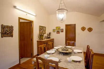 a dining room with a table and chairs at Away From Home - 2 - Home Stay Ooty, Entire 4BHK Villa in Ooty