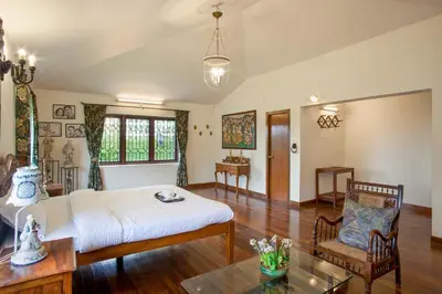 a large room with a bed and a table at Away From Home - 2 - Home Stay Ooty, Entire 4BHK Villa in Ooty