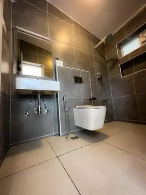 a bathroom with a sink and a toilet at Away From Home - 3 - HomeStay Ooty, Entire 3BHK Villa in Ooty