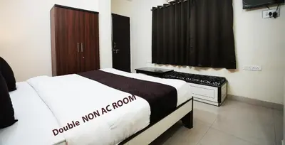 a hotel room with a bed and a window at Hotel Saran Palani in Palani