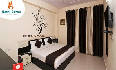 a bedroom with a bed and a tv in it at Hotel Saran Palani in Palani