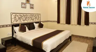 a bedroom with a large bed in a room at Hotel Saran Palani in Palani