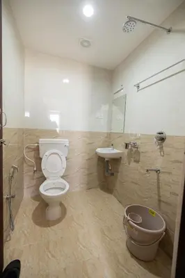 a bathroom with a toilet and a sink at Viba Residency in Coimbatore