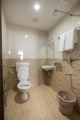 a bathroom with a toilet and a sink at Viba Residency in Coimbatore