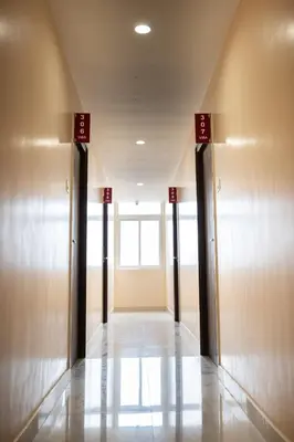 a hallway of a building with doors and a window at Viba Residency in Coimbatore