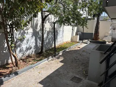 an empty alley with a fence and trees next to a building at Heart of Mysore - Entire Place for yourself in Mysore