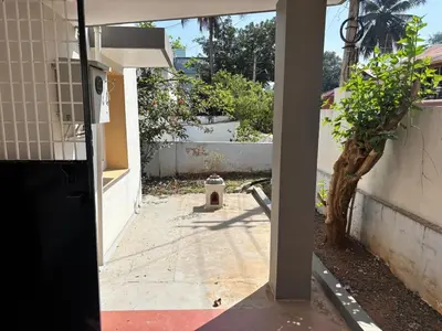 an open door of a house with a tree at Heart of Mysore - Entire Place for yourself in Mysore