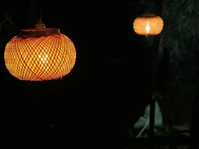 a close up of two chinese lanterns at night at Little Bricks Reverside Private Pool Villa by GreenEscapes in Vythiri
