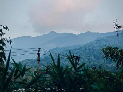 a view of a mountain range with mountains in the background at Little Bricks Reverside Private Pool Villa by GreenEscapes in Vythiri