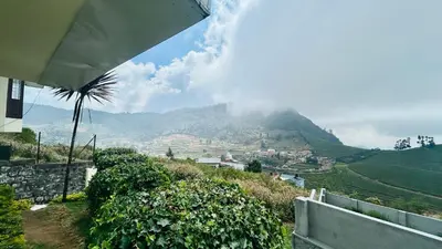 a view of a mountain from a house at Away From Home - 1 - Rooms In Ooty, Home Stay Ooty in Ooty