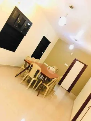 a dining room table and chairs in a room at Greenyard cottage in Ooty