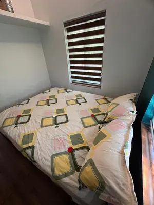 a bed with a quilt on it in a bedroom at Dragster Pool Villa in Māla