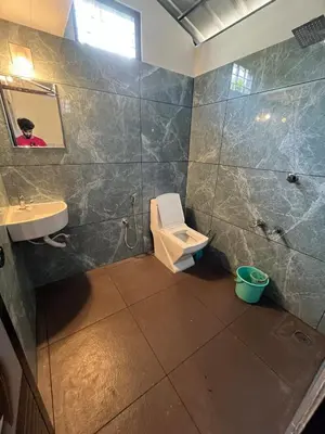 a bathroom with a toilet and a sink at Dragster Pool Villa in Māla