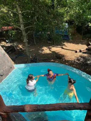 three girls are playing in a swimming pool at Dragster Pool Villa in Māla