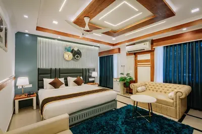 a hotel room with a bed and a couch at Excellency Airport Hotel in Ernakulam