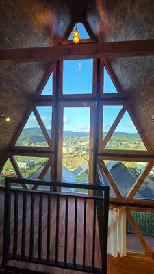 a window in a room with a view of the countryside at Fairyland Resort in Kodaikānāl