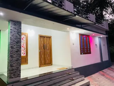 a house with two doors and a staircase on it at In-woods stay in Olavakod Junction