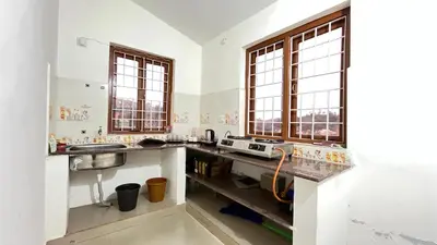 a kitchen with two sinks and two windows at Chillz Heaven Resorts - Ketti Palada in Coonoor