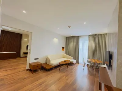 a living room with a couch and a table at Gokulam Grand Kozhikode in Kozhikode
