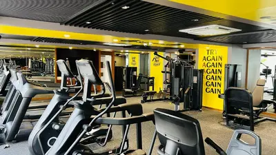 a gym with treadmills and elliptical machines in it at Gokulam Grand Kozhikode in Kozhikode