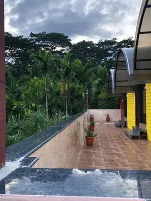 a balcony of a house with trees in the background at Galaxy Garden Resort in Kallār