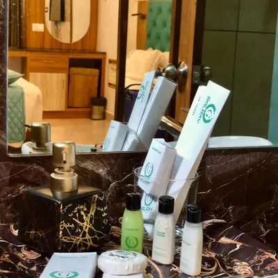 a pile of toiletries on a counter in front of a mirror at Galaxy Garden Resort in Kallār