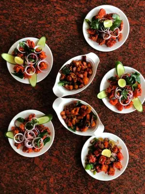 a group of plates of food on a table at Galaxy Garden Resort in Kallār